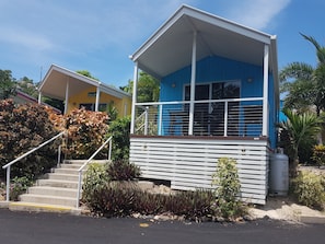 A two-story building with a blue upper level and a yellow lower level. - Horseshoe Bay Resort (Bowen)