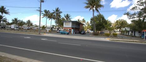 A street view with a building that has a sign indicating a business establishment.