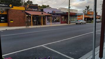A street view with storefronts including Cellarbrations, Revelations, and Foster Seafood.
