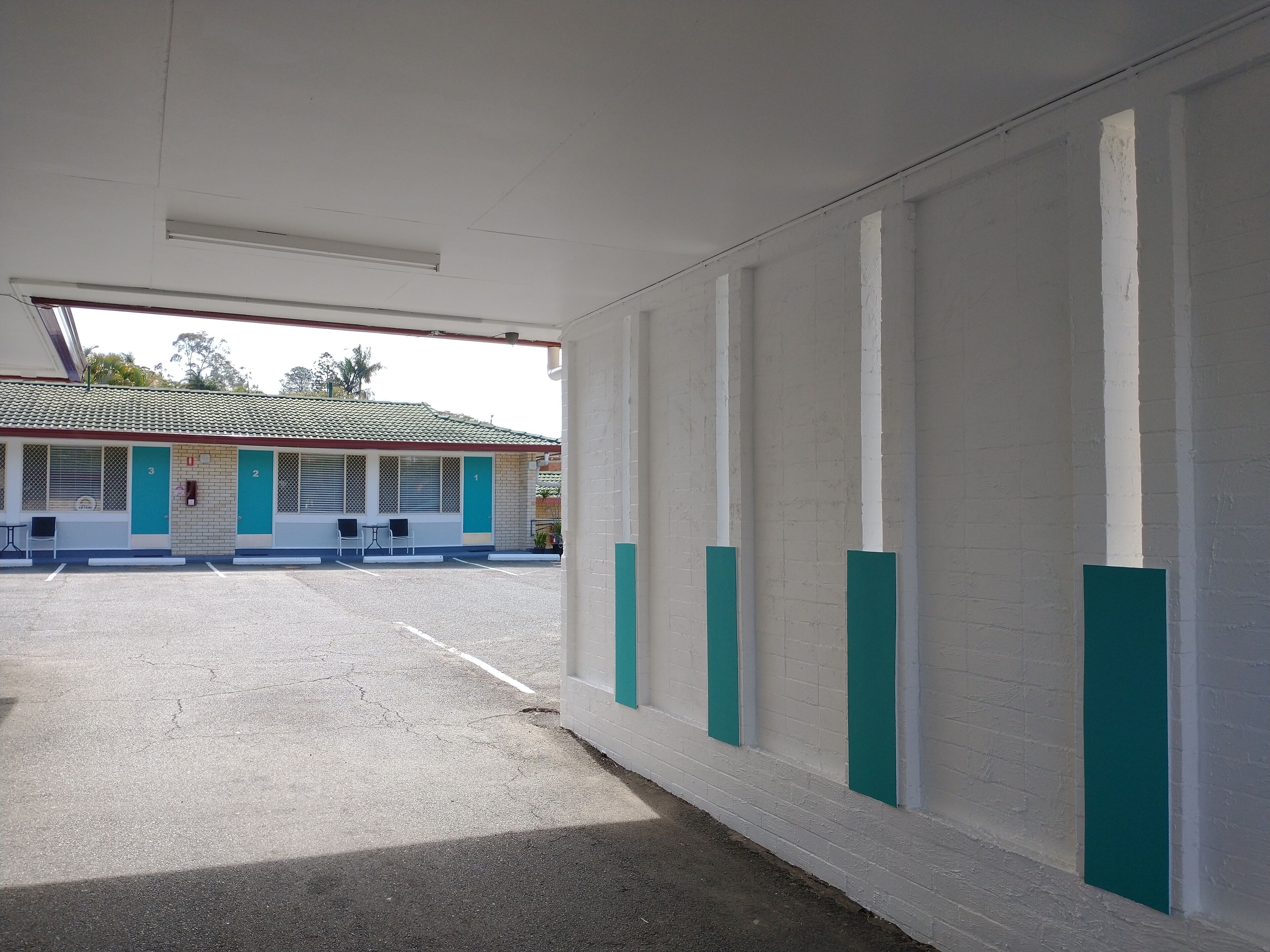 A parking area with a building in the background.