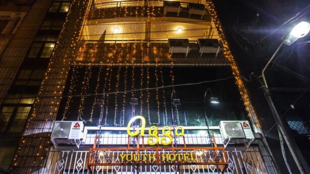 A building with multiple floors, decorated with string lights. The entrance has a sign reading "YOUTH HOTEL". - Agga Youth Hotel (Yangon)