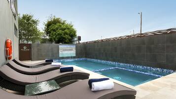 Outdoor pool, open 7:00 AM to 8:00 PM, pool loungers