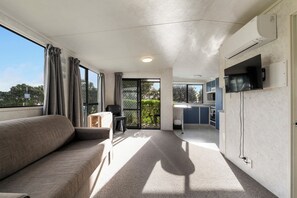 Deluxe Room, 2 Bedrooms | Living area | 32-inch LCD TV with digital channels