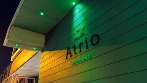 A building facade with the name 'Atrio' and the word 'Apartments' indicating it is a residential building. - Atrio Apartments (Fortitude Valley)