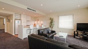 A modern apartment with a living room, kitchen, and dining area. - The Waterfront Apartments, Geelong (Geelong)