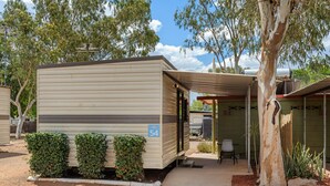 A mobile home with a covered patio, number 54, surrounded by greenery and trees. - Discovery Parks - Mount Isa (Winston)