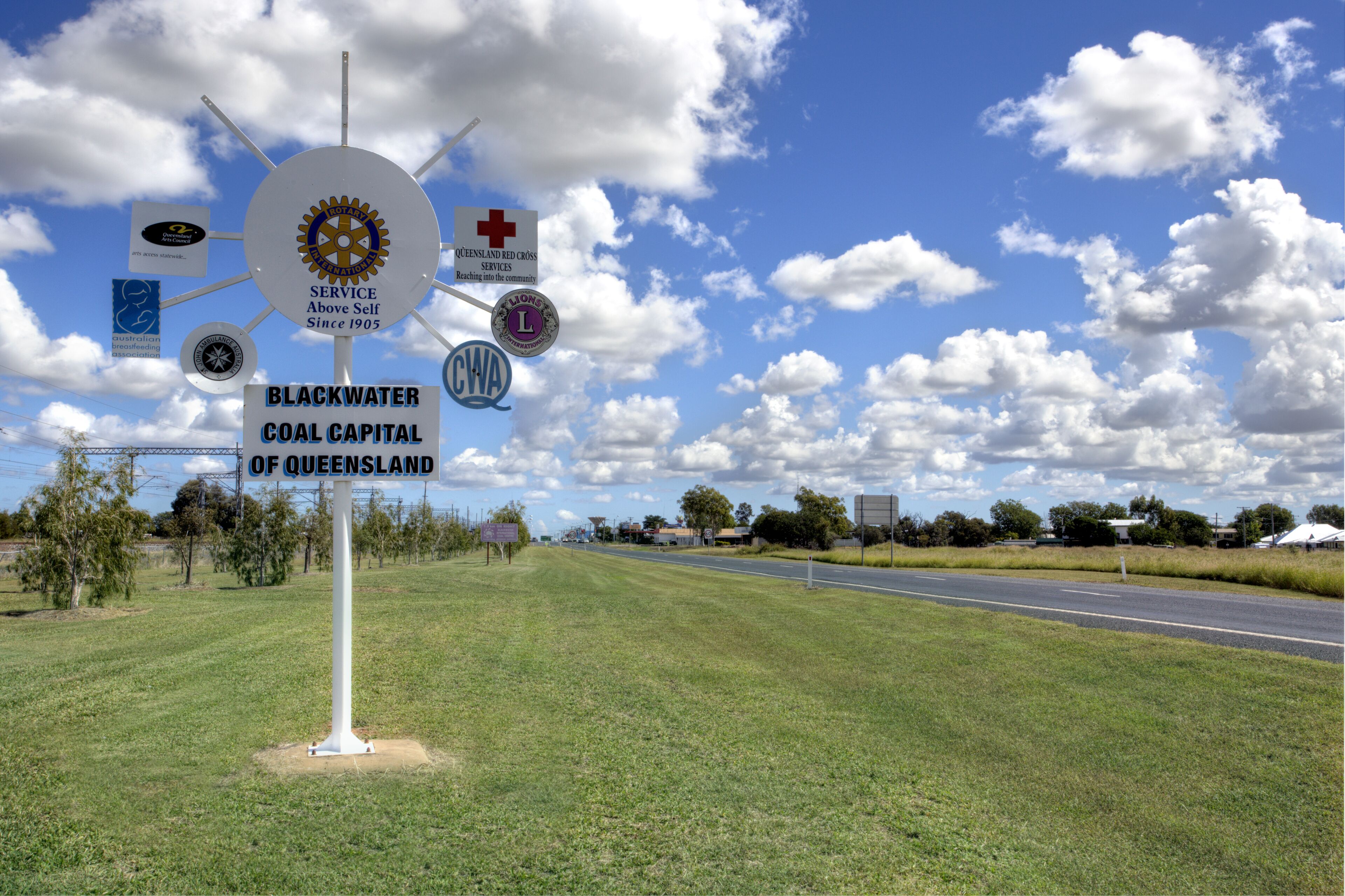 A signpost with multiple logos and the text "Blackwater Coal Capital of Queensland".