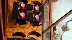 A dining area with tables set for four, each with a pair of chopsticks and a bowl. - Alpenhorn (Thredbo)