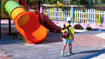 Children can play safely in this enclosed playground featuring a prominent slide structure.