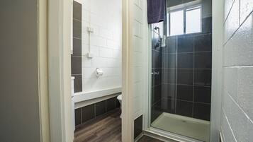 A bathroom with a shower, toilet, and a sink.