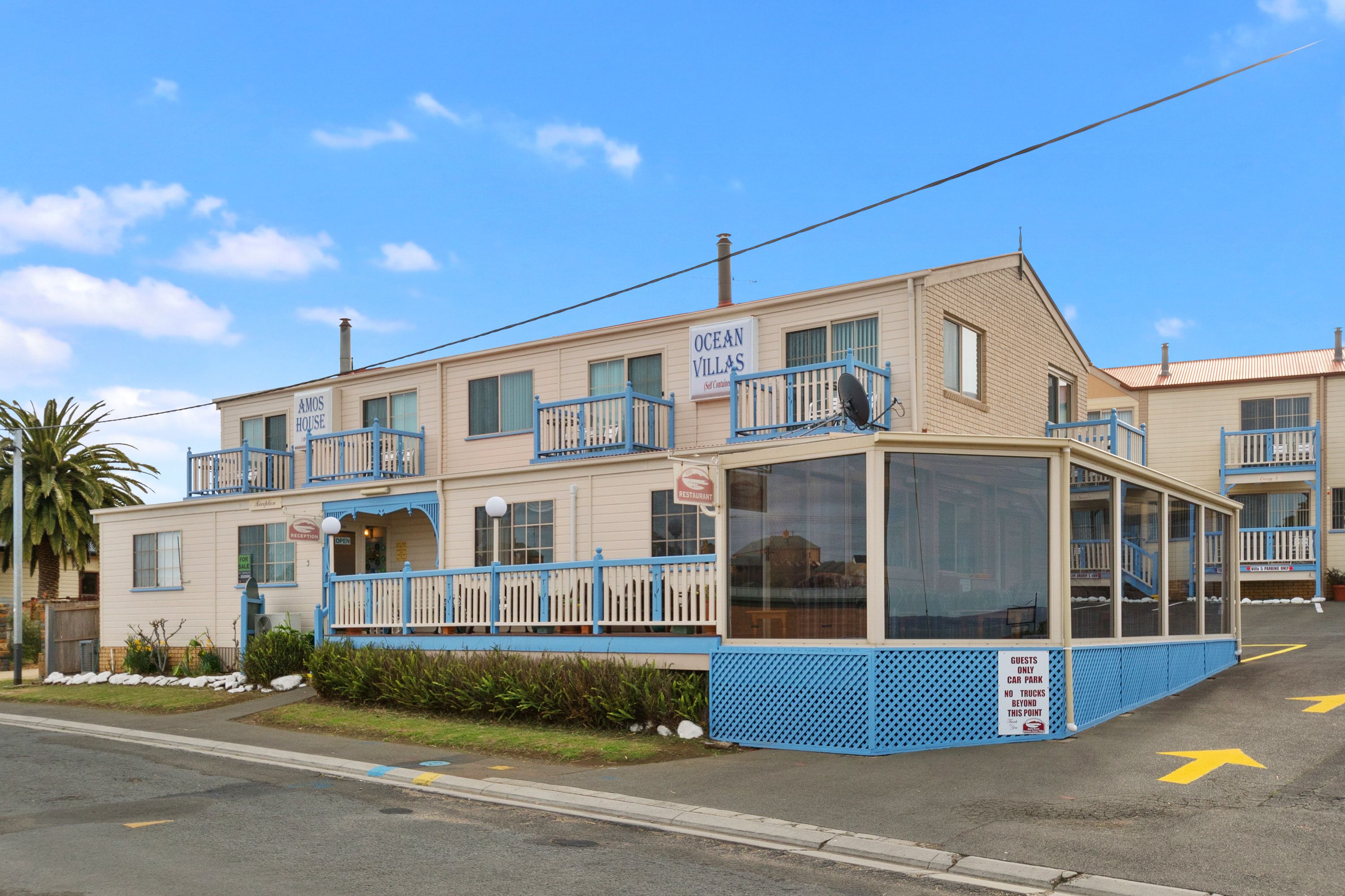 A two-story building with a sign reading "Ocean Villas."
