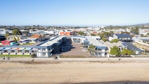 A coastal hotel with multiple buildings, a parking area, and a sandy beach in the foreground. - Best Western Port Lincoln (Port Lincoln)