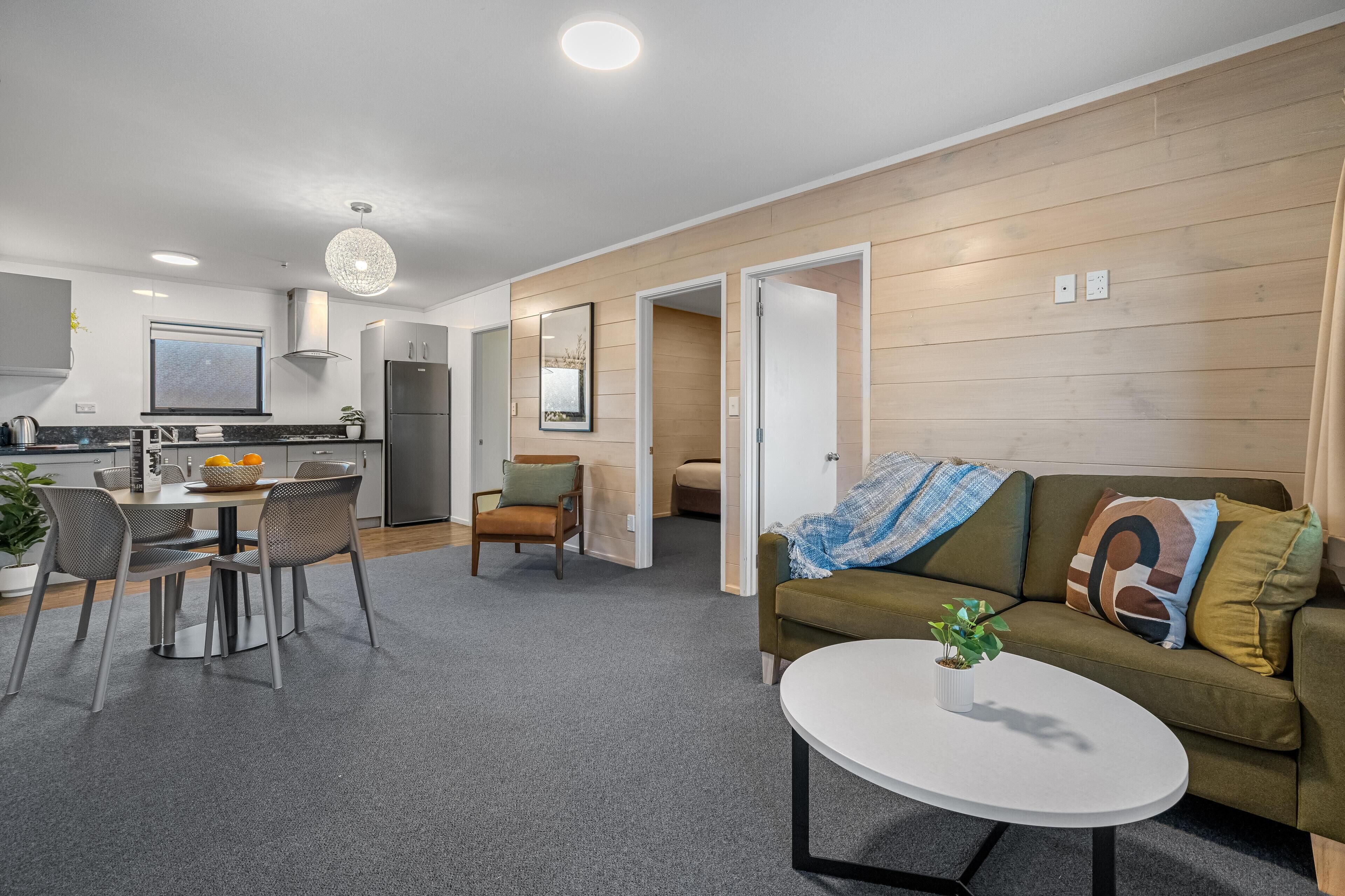 A modern apartment with a kitchen, dining area, and living room.
