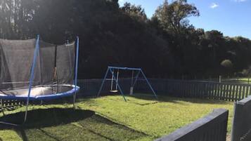 Enjoy a safe and playtime with a trampoline, swing set, and fenced play zone.