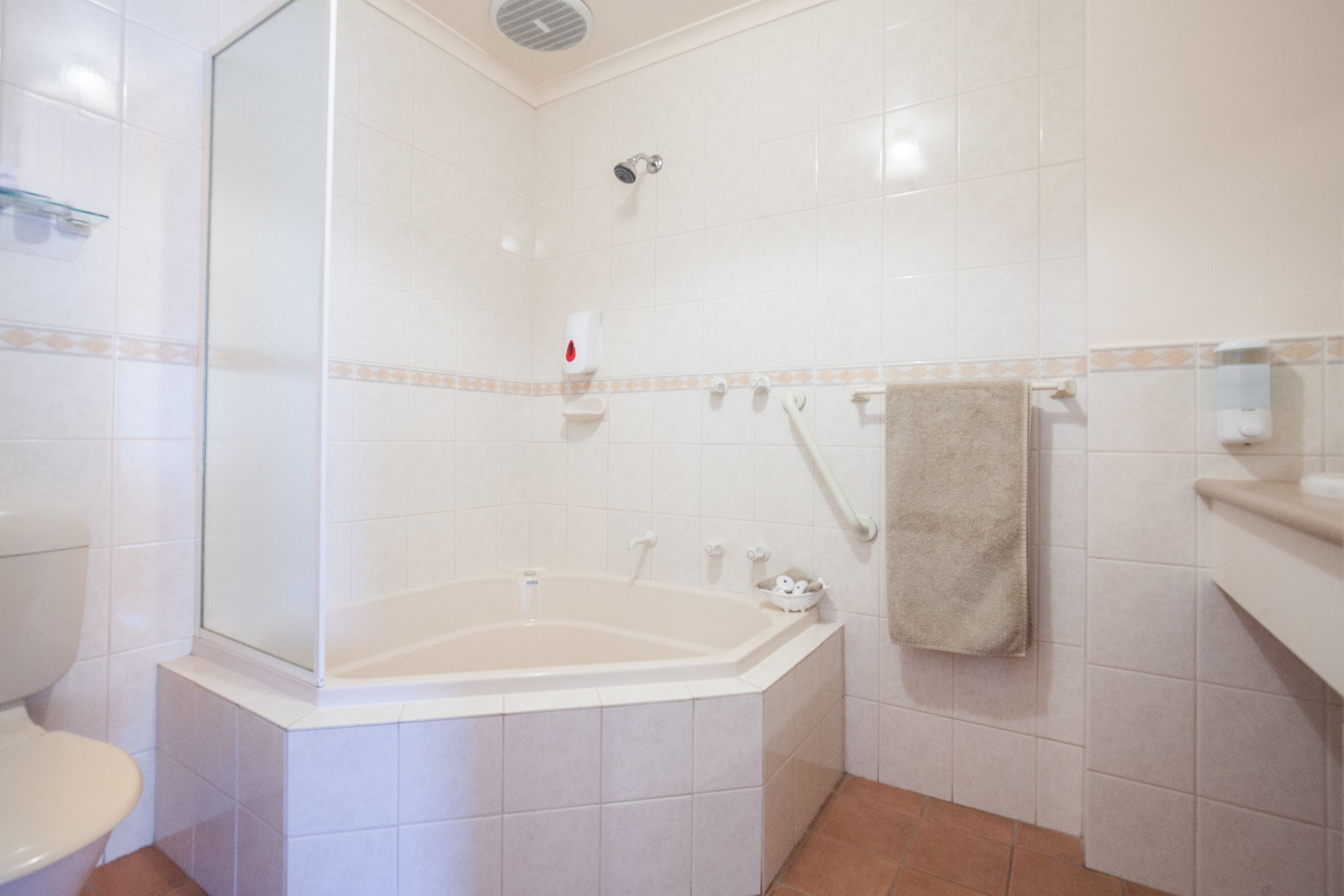 A bathroom with a bathtub, toilet, and shower.