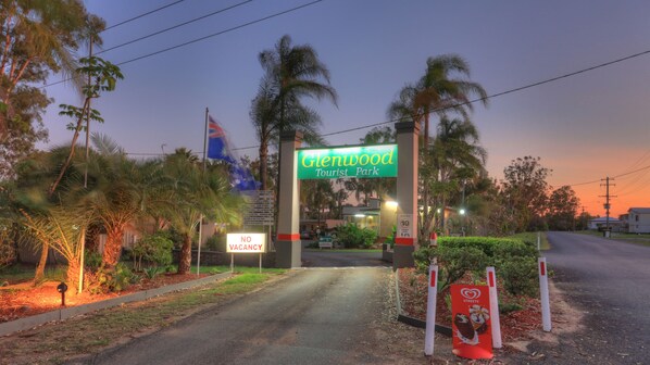 The entrance to Glenwood Tourist Park with a 'No Vacancy' sign, a 'Check In' sign, and a 'Strictly 10' speed limit sign. - Glenwood Tourist Park & Motel (South Grafton)