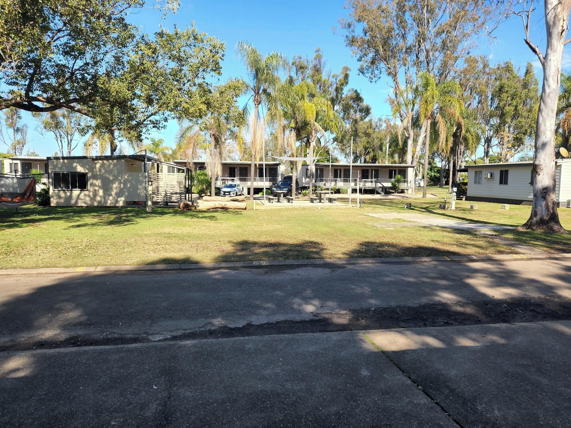 A campground with RVs, mobile homes, and a picnic area.