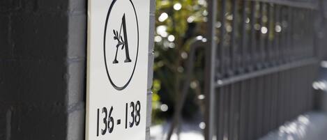 A sign with a logo and the numbers 136-138, mounted on a wall.
