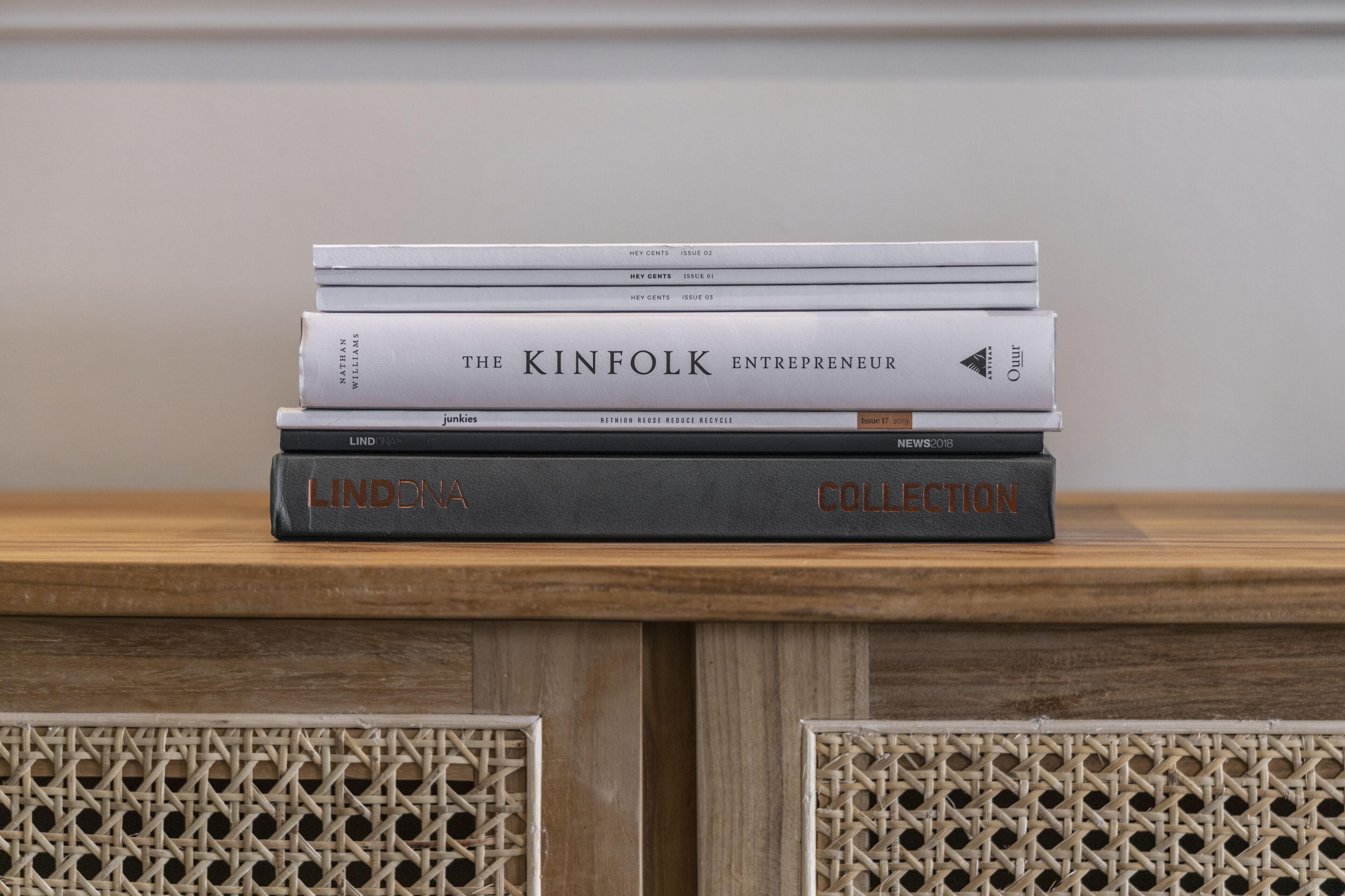 A stack of books on a wooden surface.