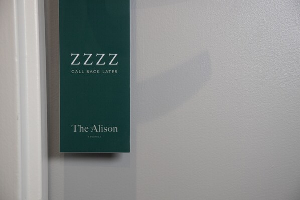 A green sign with the text "ZZZZ CALL BACK LATER" and "The Alison RANCHWICK" on a white wall.