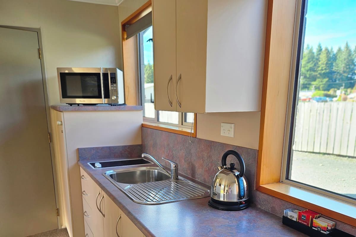 Standard Suite, 1 Queen Bed, Garden View | Private kitchen | Fridge, microwave, coffee/tea maker, electric kettle