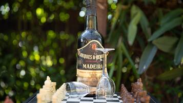A bottle of Madeira wine on a chessboard with pieces.