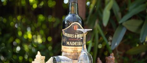 A bottle of Madeira wine on a chessboard with pieces.