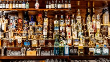 A bar with a variety of liquor bottles and glasses.