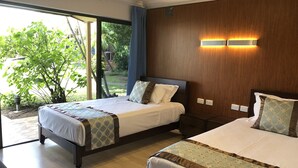 A hotel room with two beds, a large window with a view of greenery, and a wooden wall with built-in lighting. - Oxley Motor Inn (Oxley)