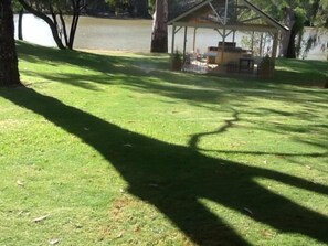 A grassy area with a gazebo and a body of water in the background. - Euston Club Motel (Euston)
