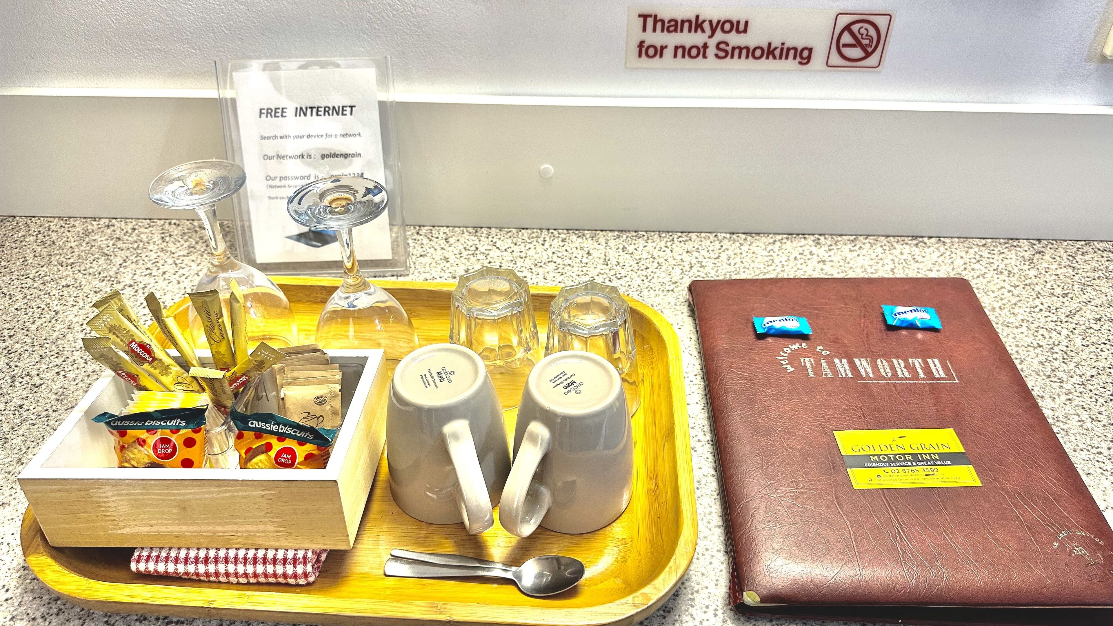 A tray with food items, a bottle, and a sign offering free internet.