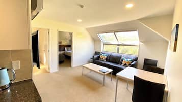 Family Apartment, 2 Bedrooms | Living area | 42-inch TV with digital channels