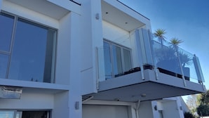 A modern two-story building with large windows and a balcony. - Alpha Motel Christchurch (Christchurch)