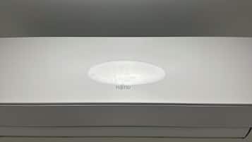 A white ceiling with a recessed light fixture and a Fujitsu logo.