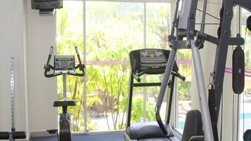 A gym with cardio equipment, a treadmill, and a stationary bike.