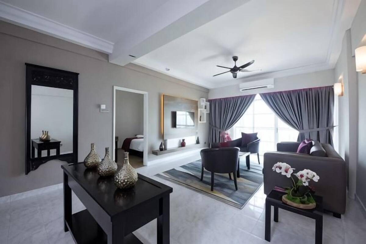 A modern living room with a sofa, a coffee table, and decorative vases.
