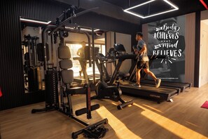 A gym with treadmills, weight machines, and a motivational poster. - Horison Ultima Bekasi (Bekasi)