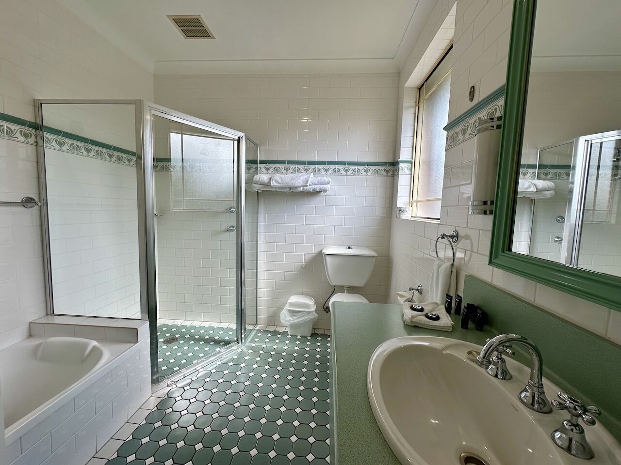 A bathroom with a bathtub, shower, toilet, and sink.