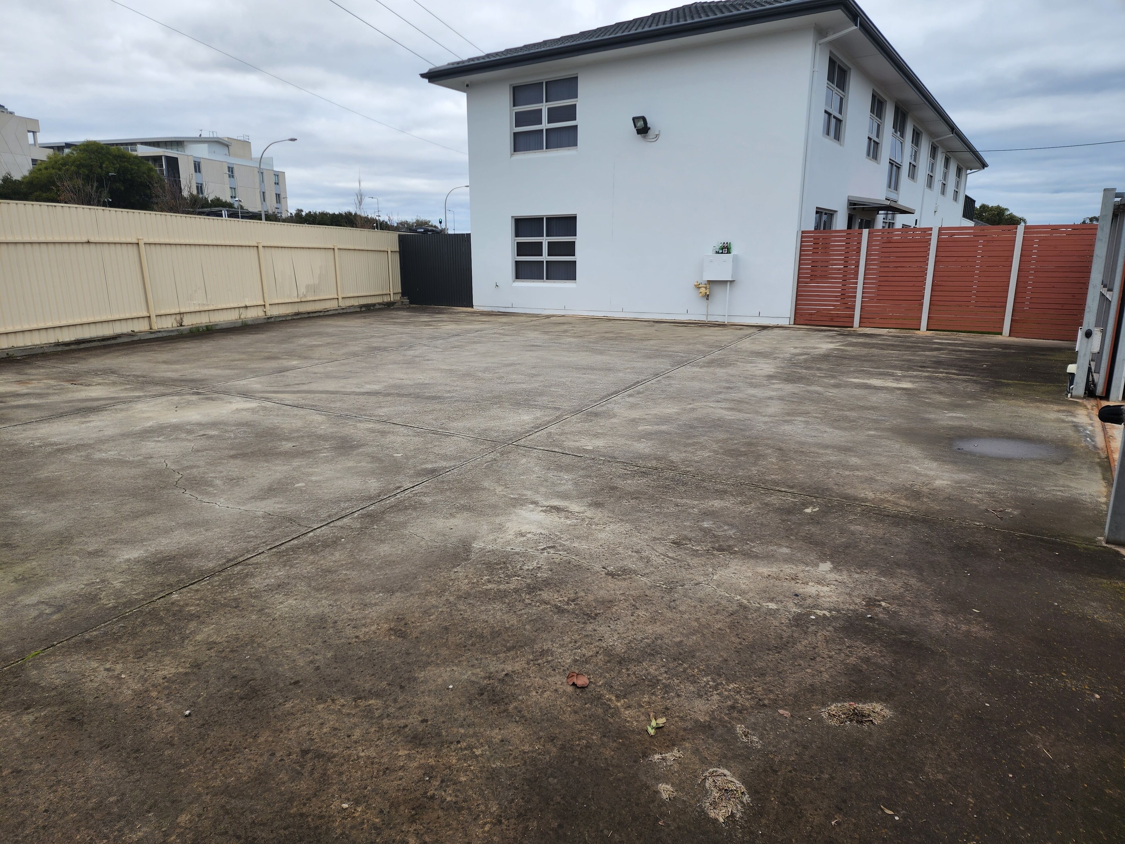 A large, open concrete area with a white building in the background.