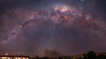 A night sky with visible stars and the Milky Way.