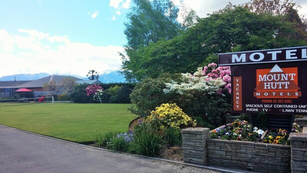 A motel sign with a garden in front. - Mount Hutt Motels (Methven)