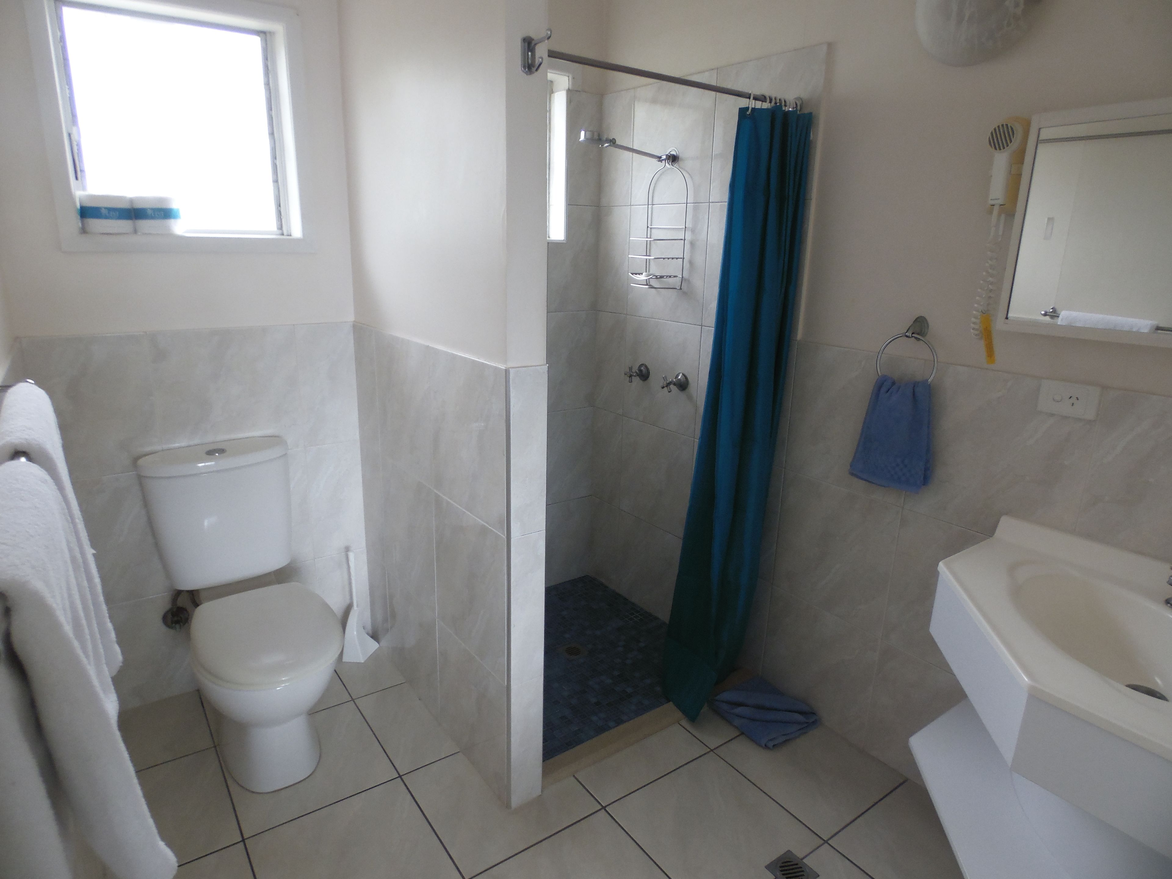 superior studio suite | bathroom | shower, hair dryer, towels