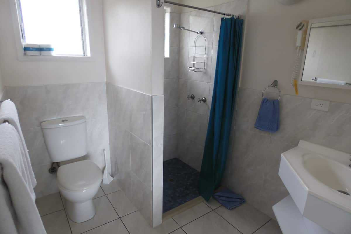 superior studio suite | bathroom | shower, hair dryer, towels
