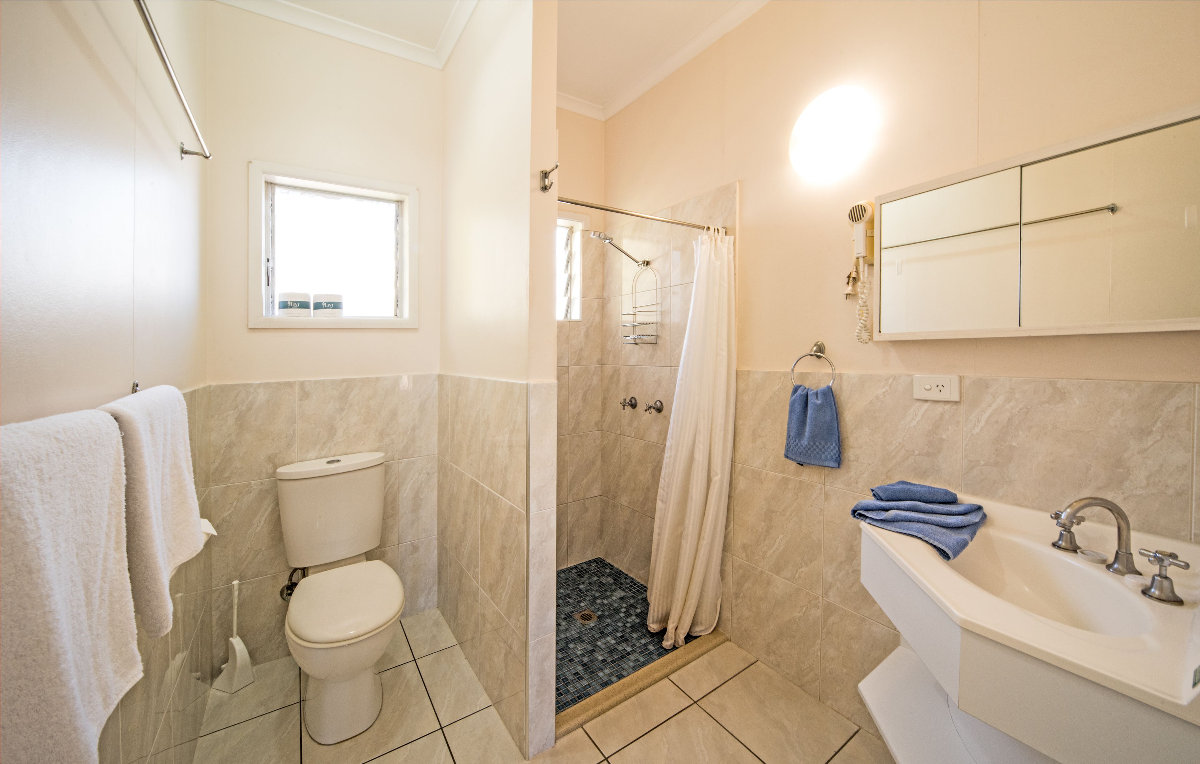 superior studio suite | bathroom | shower, hair dryer, towels