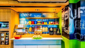 A breakfast bar with shelves stocked with dairy products, condiments, and baked goods.