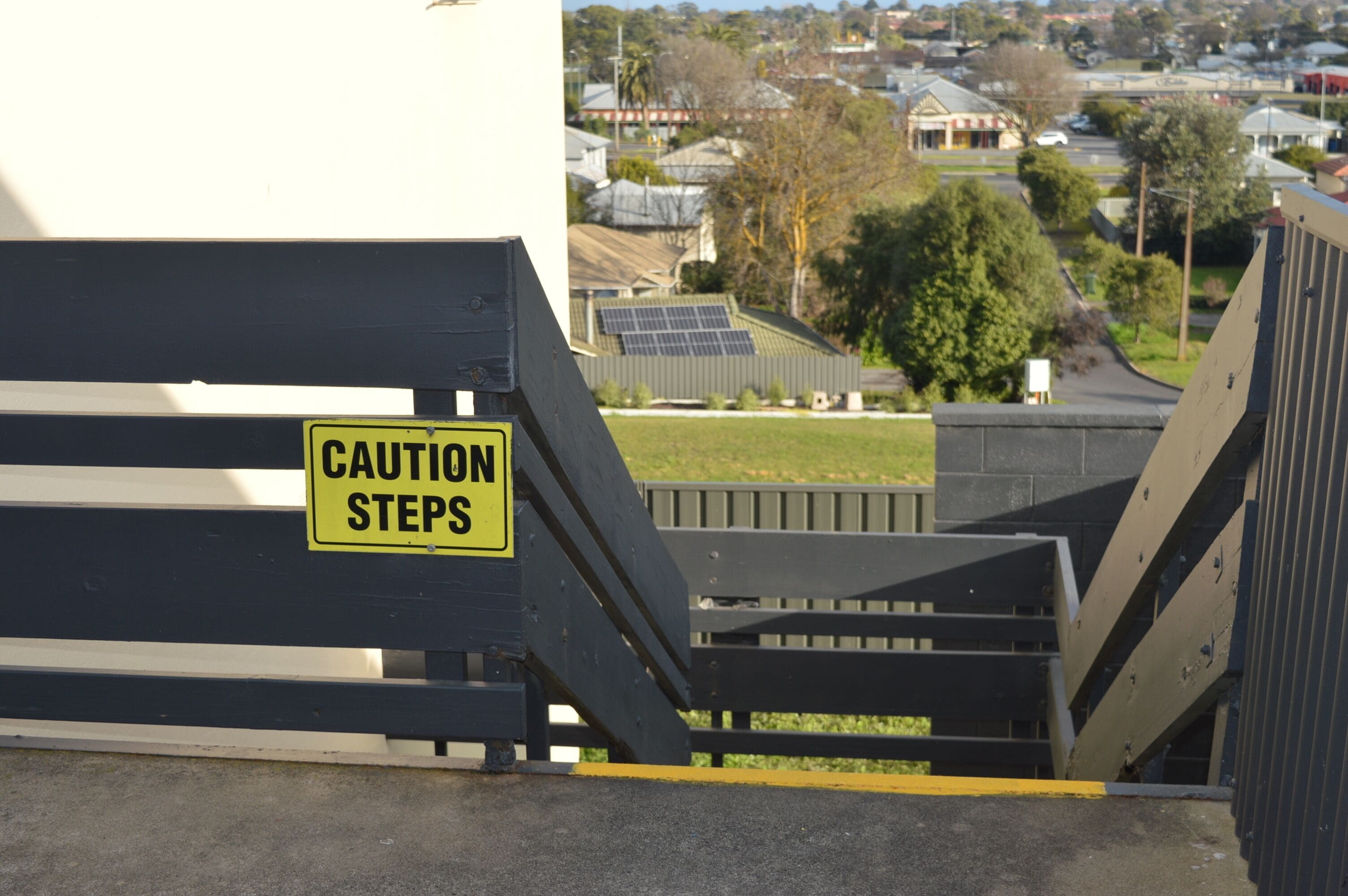 A caution sign on a staircase.