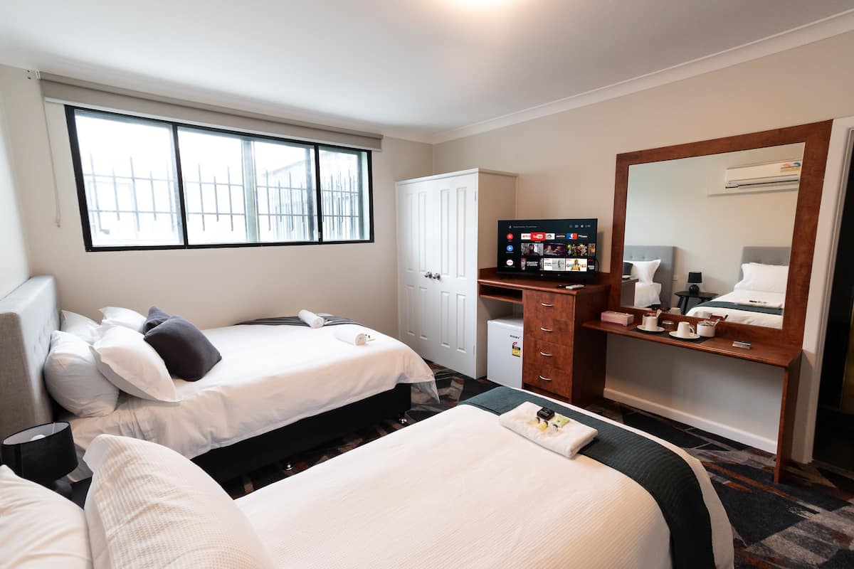 Desk, iron/ironing board, bed sheets