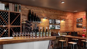 A bar area with wooden walls, wine bottles, glasses, and stools. - Glen Erin At Lancefield - Vineyard Retreat (Lancefield)