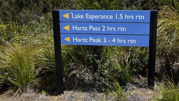 A directional sign with arrows pointing to Lake Esperance, Hartz Pass, and Hartz Peak with estimated hiking times.