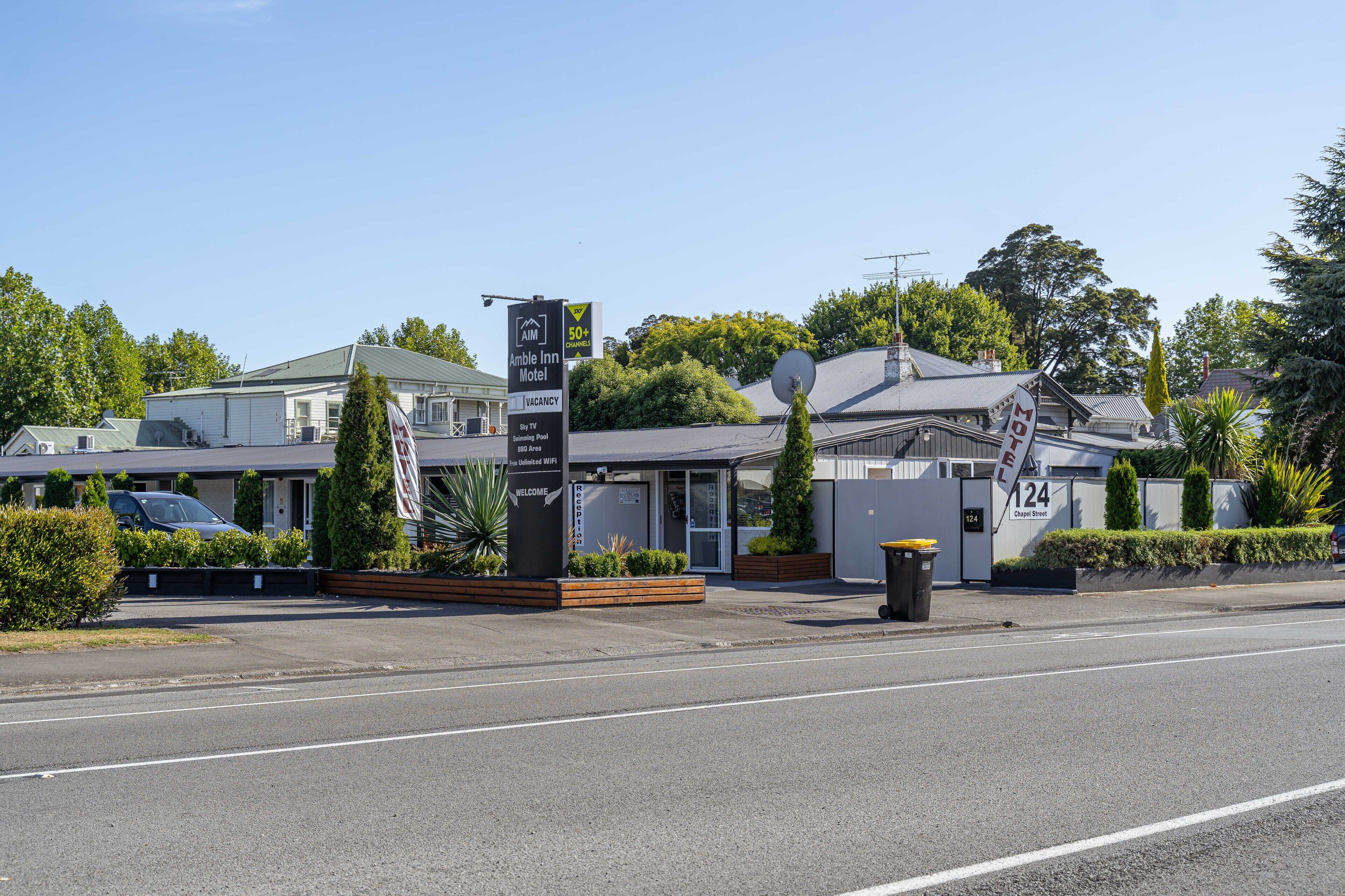 A motel with a signboard indicating amenities like free Wi-Fi and a 50+ years of experience.